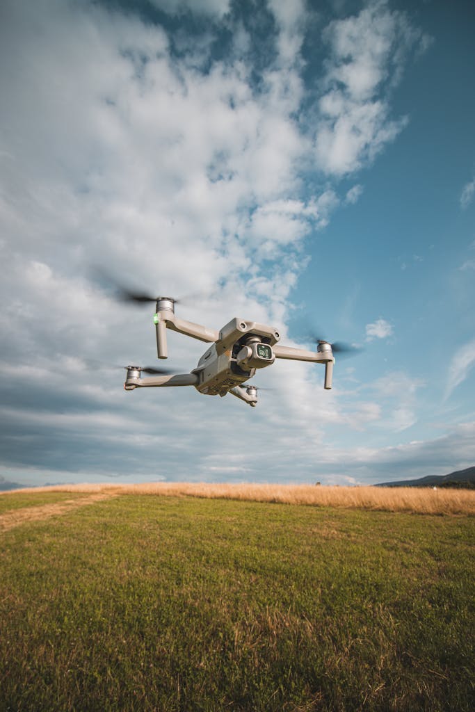A small drone flying over a field